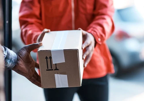 cropped-shot-of-a-delivery-man-handing-over-a-pack-2023-11-27-05-35-46-utc.jpg